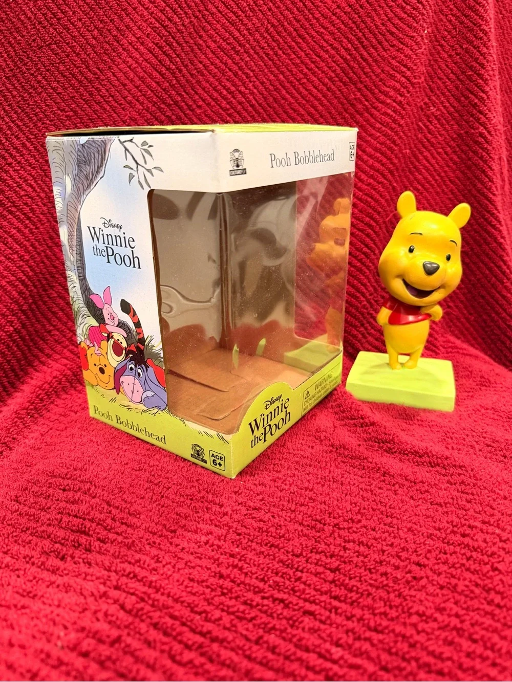 Disney Winnie the Pooh Yellow Figurine with Red Shirt and Green Base